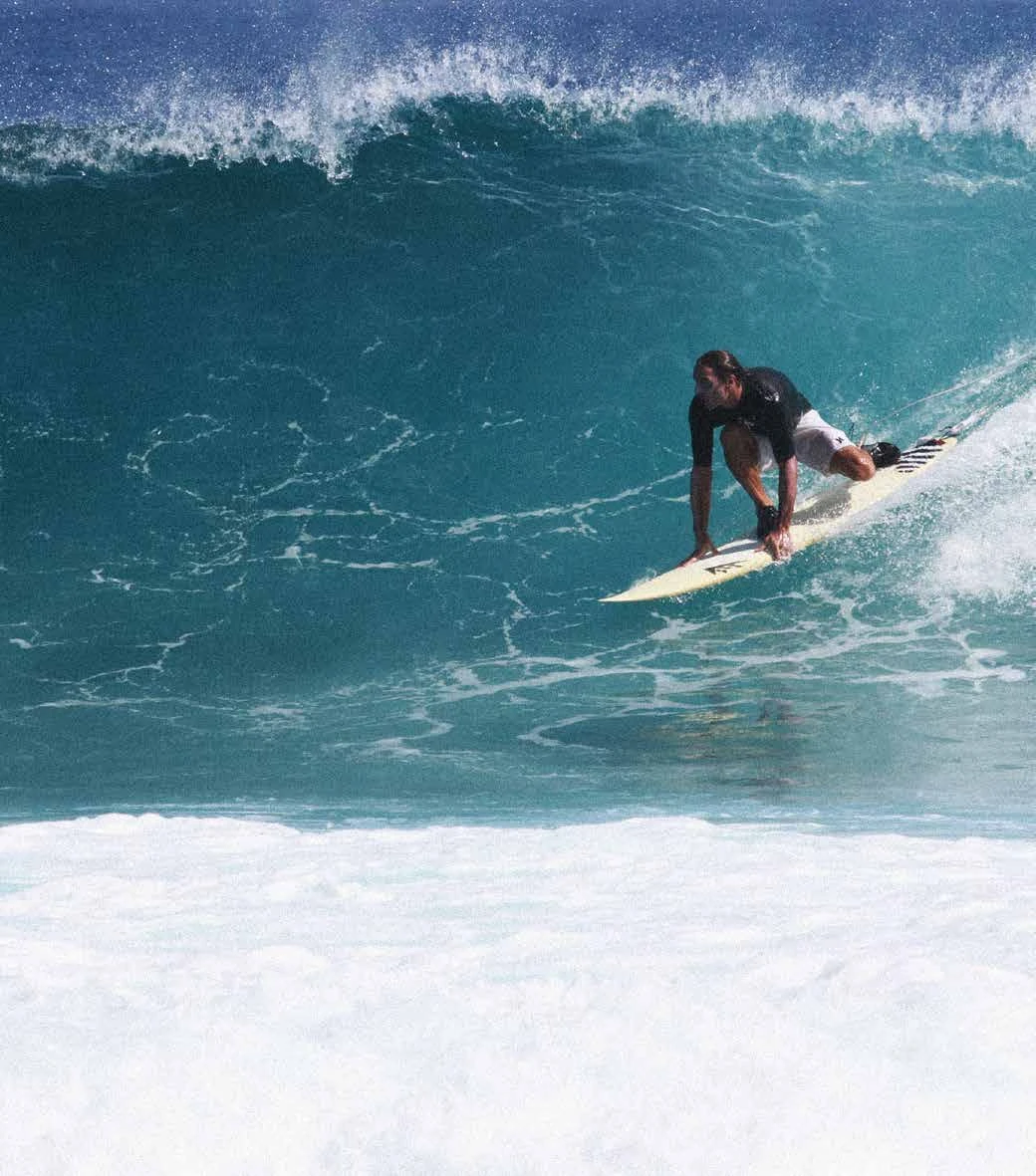 Marco Pizzuti, founder of Adno, surfing a wave